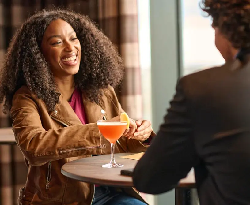 Woman and man having drinks at a table